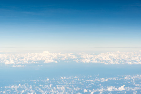 Cloudscape skyline view above white clouds from airplane