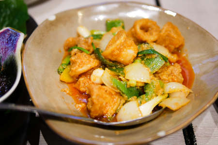 Stir fried squid with salted egg on brown disk