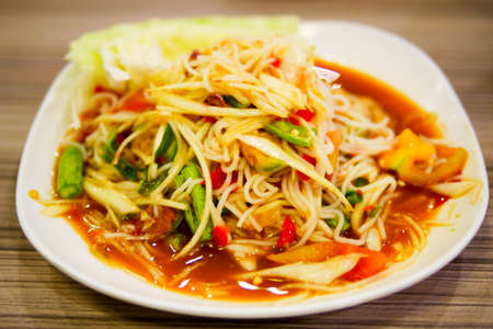 Papaya salad with noodle and tomato, traditional spicy Thai food that is one of the most popular in...