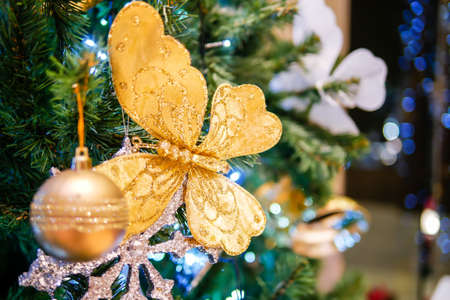 christmas tree with gold ball and butterfly glitterの写真素材