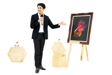 Smart Asian men is presenting the beautiful siamese fighting fish (betta) photo in the museum...