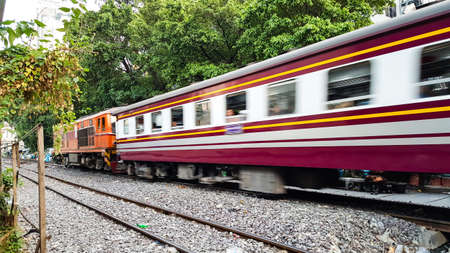 BANGKOK, THAILAND - FEBRUARY 15, 2018: The traditional Thai trains are sailing past the city center in the afternoon.のeditorial素材
