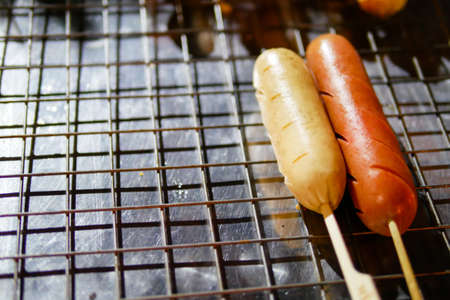 Isaan sausage being grilled on the traditional stove that be a part of street food in Thailandの写真素材