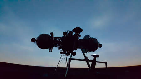 the huge of projector in interior of planetarium with the darkness of the auditorium