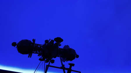 the huge of projector in interior of planetarium with the darkness of the auditorium