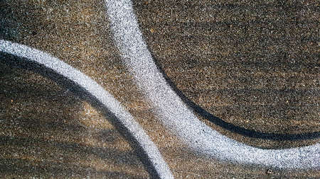 Black and brown color of asphalt walkway in the parks or garden with the small stones texture in top...