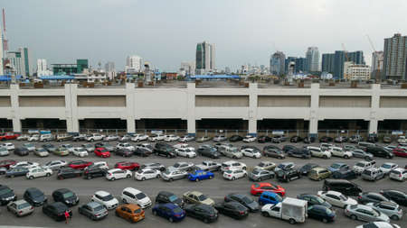 Bangkok, Thailand - May 23, 2020: Cars parked in outdoor parking lot at Mo Chit BTS station with...