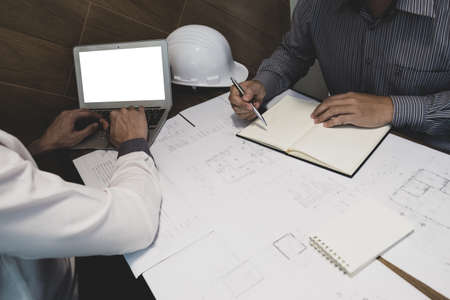 The engineer and partner are discussing about construction plan at the office, Vintage tone,...