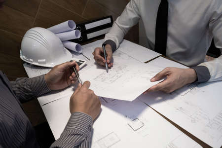 The engineer and partner are discussing about construction plan at the office, Vintage tone,...