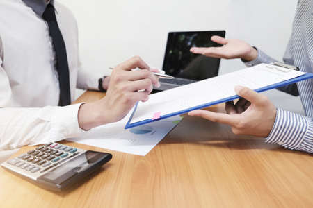 Businessman is presenting a new project to his boss and taking about work.の写真素材