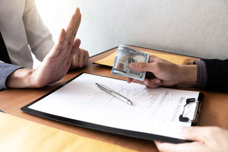 The businessmen refusing accept bribes at the office, Bribery and corruption concept.