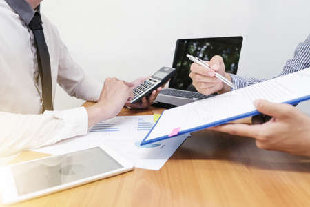 Businessman is calculating the budget that employee is offering and taking about work.の写真素材
