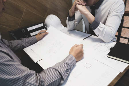The engineer and partner are discussing about construction plan at the office, Vintage tone, Engineering concept.の写真素材