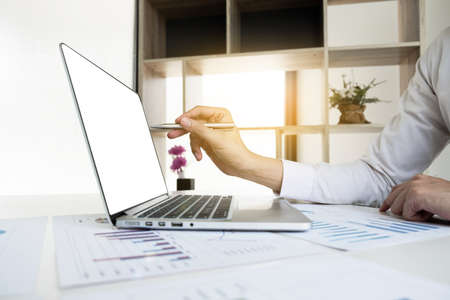 Businessman is working with computer notebook for analyze marketing strategy from the sell performance graph in the office room, Finance and accounting concept.の写真素材