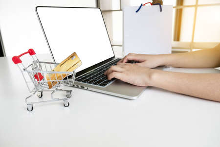 Closeup hand of women is using computer notebook for shopping online.の写真素材
