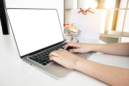 Closeup hand of women is using computer notebook for shopping online.の写真素材