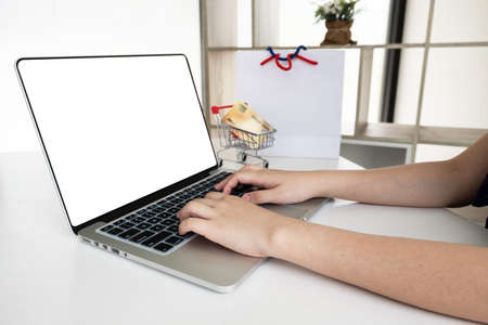 Closeup hand of women is using computer notebook for shopping online.の写真素材