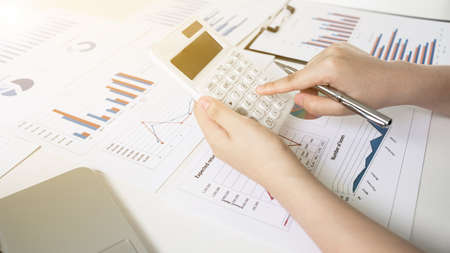 Business women is calculating revenue from graph in the room and work from home, Finance and accounting concept.の写真素材