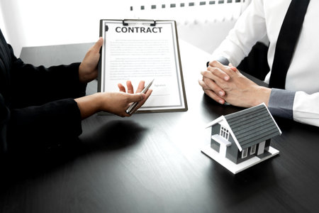 A loan officer is talking to a customer about a house leasing contract, Property concept.の写真素材