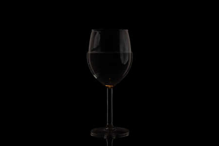 A glass of wine on a black backgroundの写真素材