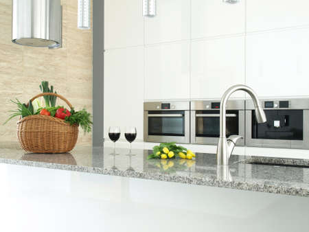 Modern kitchen interior with vegetables, glasses of wine and flowers