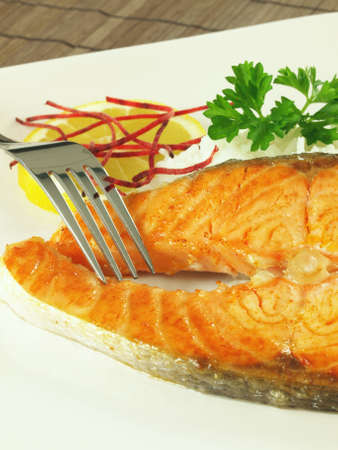 Fried salmon fillet with rice and parsleyの写真素材