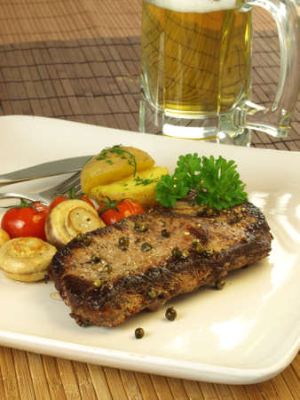 Grilled beef dish with beerの写真素材