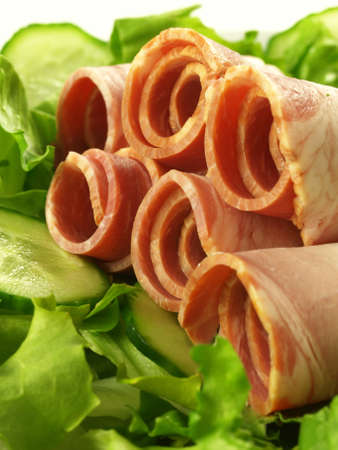 Rolled sirloin with green lettuce and cucumber, closeup