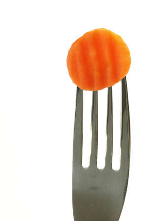 Slice of carrot on fork on isolated backgroundの写真素材