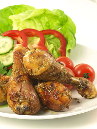 Plate with chicken legs from grill and saladの写真素材