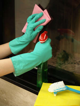 Scrubbing the fireplace glass with detergent and cloth