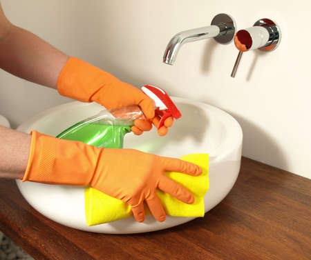 Cleaning up the bathroom sink with detergent