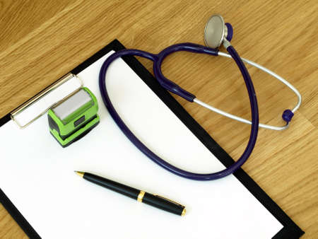 Stethoscope, stamp and notebook on the doctor's desk