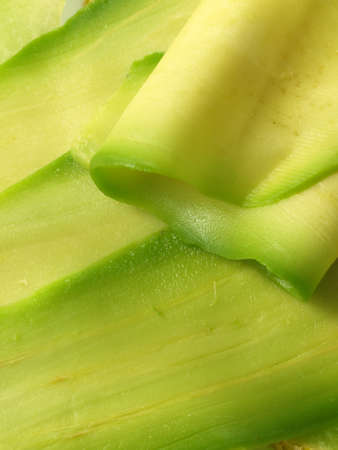 Closeup of avocado slices, green backgroundの写真素材