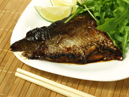 Fried fillet of salmon with arugula leaves