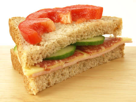 Cheese, ham and salami sandwich with slice of pepperの写真素材
