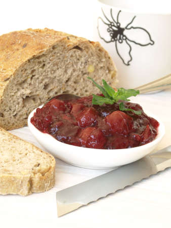 Bowl of homemade strawberry jam and wholemeal bread
