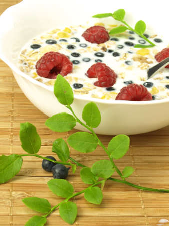 Milk with raspberries, blueberries and oat flakesの写真素材