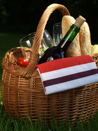 Basket with french wine and baguette for picnicの写真素材