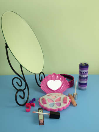 Mirror and cosmetics on a blue tableの写真素材