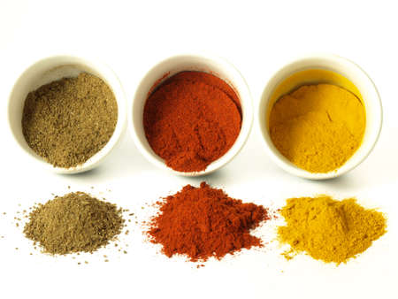Turmeric, cumin and hot pepper on isolated backgroundの写真素材