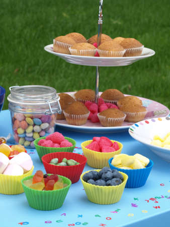 Kinder party in the garden with colorful swetsの写真素材