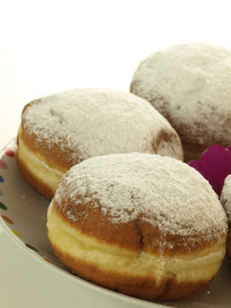 Sweet donuts with castor sugar on white plateの写真素材