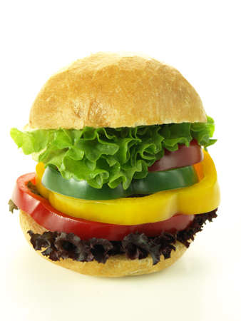 Bun with pepper slices and lettuce leaves, isolated background