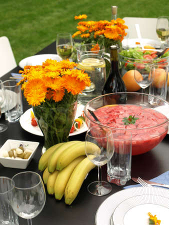 Bananas, flowers and punch on a summer table