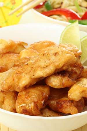 Golden fried fish sticks with vegetables and lime