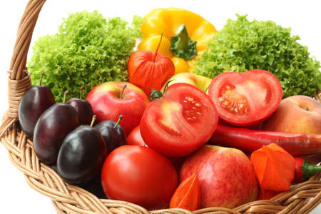 Closeup of vegetables in wicker basket, isolated backgroundの写真素材
