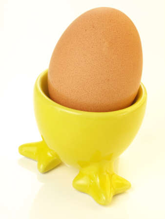 Boiled egg in yellow egg cupの写真素材