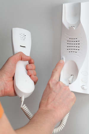 Pushing the button of the entry phone, opening the door