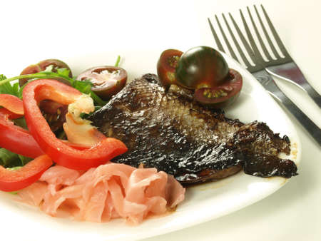 Fried fillet of fish with vegetables and spicesの写真素材